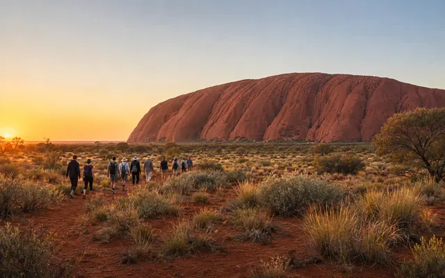 Guided walking group near Uluru at sunrise
