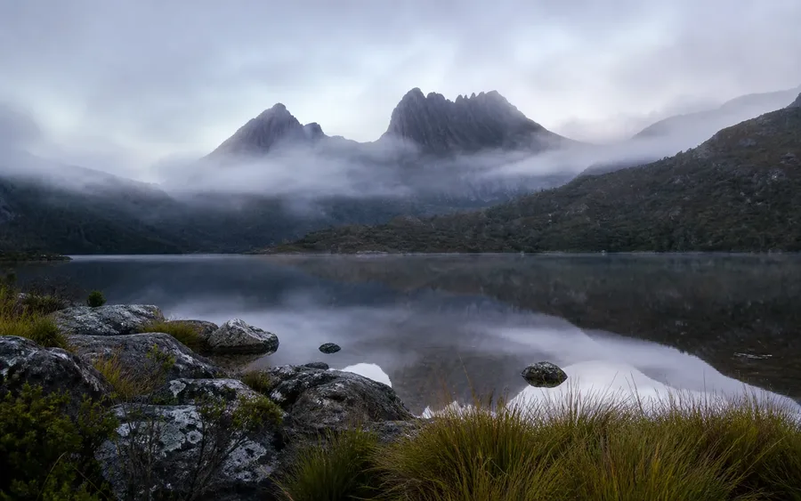 Cradle Mountain reflected in Dove Lake beneath morning mist